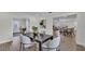 Dining room showcasing hardwood flooring, modern light fixture, neutral wall color, and open floor plan at 4028 S Wellington Dr, Lakeland, FL 33813