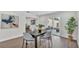 Dining area showcases hardwood floors, modern decor and furniture with natural light leading to the backyard at 4028 S Wellington Dr, Lakeland, FL 33813