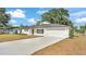 Beautifully renovated, white brick home with a modern garage and long driveway provides ample parking at 4028 S Wellington Dr, Lakeland, FL 33813
