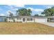 Charming white brick home with a manicured lawn and a black front door, offering great curb appeal at 4028 S Wellington Dr, Lakeland, FL 33813