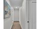 Hallway with neutral paint, luxury vinyl flooring and white doors at 4028 S Wellington Dr, Lakeland, FL 33813