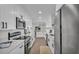 White kitchen features stainless steel appliances, stone countertops and cabinetry with modern hardware at 4028 S Wellington Dr, Lakeland, FL 33813