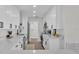 Galley style kitchen boasts white cabinets, quartz counters, stainless steel appliances and modern fixtures at 4028 S Wellington Dr, Lakeland, FL 33813