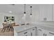 Eat-in kitchen showcasing white cabinets, quartz counters, modern hardware and stainless pendant lighting at 4028 S Wellington Dr, Lakeland, FL 33813