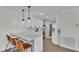 Bright kitchen with white cabinetry, quartz countertops, modern appliances, and bar seating with pendant lighting at 4028 S Wellington Dr, Lakeland, FL 33813