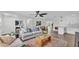Bright living room featuring neutral walls, hardwood floors, ceiling fan, modern furnishings and an adjacent dining area at 4028 S Wellington Dr, Lakeland, FL 33813
