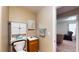 Modest bathroom with vanity, toilet, mirror, towel bar, and access to living room at 410 Orange St, Bradley, FL 33835