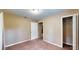 Bedroom featuring carpeted floors, tan walls, closet, single window, and doorway at 410 Orange St, Bradley, FL 33835