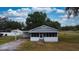 Exterior of a single-story house with a screened-in porch at 410 Orange St, Bradley, FL 33835
