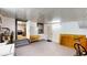 View of an indoor garage space with appliances, utility sink, storage space, and workbench leading to kitchen at 410 Orange St, Bradley, FL 33835