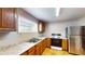 Functional kitchen with stainless steel refrigerator, wooden cabinets, and laminate countertops at 410 Orange St, Bradley, FL 33835