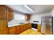 Modern kitchen featuring stainless steel appliances, plenty of cabinet space, and laminate flooring at 410 Orange St, Bradley, FL 33835
