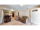 Comfortable living room with carpet, neutral paint, and access to the dining area at 410 Orange St, Bradley, FL 33835