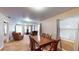 Bright living room with multiple windows and seamless transition to the adjacent dining area, great for entertaining at 410 Orange St, Bradley, FL 33835