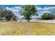 Expansive front yard with mature trees surrounding a charming single-story home at 410 Orange St, Bradley, FL 33835