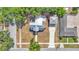 Two-story home with metal roof and detached garage with driveway, showcasing both functionality and traditional architectural elements at 410 S Broadway Ave, Bartow, FL 33830