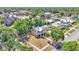 Aerial view of a two-story home with a light yellow exterior, a metal roof, and a detached garage at 410 S Broadway Ave, Bartow, FL 33830