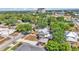 Picturesque neighborhood featuring two-story home with a front porch and a detached garage nestled among lush green trees and landscaping at 410 S Broadway Ave, Bartow, FL 33830