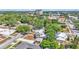 Picturesque neighborhood featuring a two-story home nestled with mature trees providing shade with lush greenery surrounding property at 410 S Broadway Ave, Bartow, FL 33830