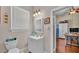 Neutral bathroom with a sink, toilet, and door to another room at 410 S Broadway Ave, Bartow, FL 33830