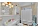 This bathroom features a clawfoot tub, a pedestal sink, and beaded wainscoting at 410 S Broadway Ave, Bartow, FL 33830