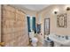 Neutral bathroom featuring a vanity sink, toilet, shower with patterned curtain, and soft lighting at 410 S Broadway Ave, Bartow, FL 33830