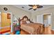 Bedroom with hardwood floors, ceiling fan, and ornate wood furniture at 410 S Broadway Ave, Bartow, FL 33830
