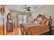 This primary bedroom offers an ornate bed frame, wood floors, and a ceiling fan at 410 S Broadway Ave, Bartow, FL 33830