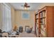 This small bedroom has a ceiling fan and a bookshelf, ideal for use as an office or study at 410 S Broadway Ave, Bartow, FL 33830