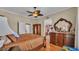 Bedroom featuring hardwood floors, a ceiling fan, and vintage furniture at 410 S Broadway Ave, Bartow, FL 33830