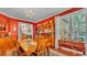 Dining room with red walls, a chandelier, hardwood floors, and plenty of natural light from the window at 410 S Broadway Ave, Bartow, FL 33830