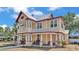 Beautiful two-story home boasts a spacious front porch and a metal roof, creating an inviting curb appeal at 410 S Broadway Ave, Bartow, FL 33830
