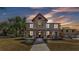 Inviting two-story home featuring a covered front porch, balcony, and metal roof, blending classic charm with modern appeal at 410 S Broadway Ave, Bartow, FL 33830