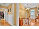 This upstairs hallway features hardwood floors, white wainscoting, and access to other rooms at 410 S Broadway Ave, Bartow, FL 33830
