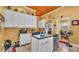 Quaint kitchen with ample counter space, stainless dishwasher, and a unique patterned ceiling at 410 S Broadway Ave, Bartow, FL 33830