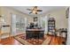 Office with hardwood floors, large windows, and a spacious dark wood desk at 410 S Broadway Ave, Bartow, FL 33830