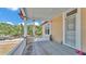 Side porch with white railings, and view of trees in the neighborhood at 410 S Broadway Ave, Bartow, FL 33830