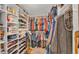 This walk-in closet has built-in shelving, hanging racks, and designated areas for accessories and shoes at 410 S Broadway Ave, Bartow, FL 33830
