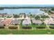 Picturesque aerial view of a neighborhood featuring well-manicured lawns and a serene lake in the background at 4219 Windchime Ln, Lakeland, FL 33811