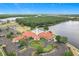 Stunning aerial view of community center with pool, tennis courts, playground, and beautiful landscaping at 4219 Windchime Ln, Lakeland, FL 33811