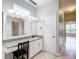 The bathroom features a vanity with a granite countertop and large mirror at 4219 Windchime Ln, Lakeland, FL 33811