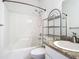 This bathroom features a shower and tub, vanity, and storage shelving at 4219 Windchime Ln, Lakeland, FL 33811