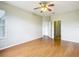 An empty bedroom features a ceiling fan and wood-look flooring at 4219 Windchime Ln, Lakeland, FL 33811