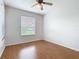 The bedroom has a ceiling fan and large window for natural light at 4219 Windchime Ln, Lakeland, FL 33811