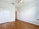 Bright bedroom features hardwood floors, closet, and a ceiling fan at 4219 Windchime Ln, Lakeland, FL 33811