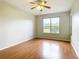 This bedroom features hardwood flooring, a ceiling fan, and a large window at 4219 Windchime Ln, Lakeland, FL 33811