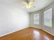This bedroom is bright with natural light, ceiling fan, and hardwood floors at 4219 Windchime Ln, Lakeland, FL 33811