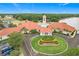 Beautifully landscaped entrance to the clubhouse with well-maintained gardens and ample parking at 4219 Windchime Ln, Lakeland, FL 33811