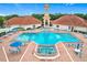 Resort-style community pool with a jacuzzi and many tables and chairs surrounding the pool at 4219 Windchime Ln, Lakeland, FL 33811
