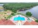 Aerial view of the community pool with plenty of lounge chairs and umbrellas at 4219 Windchime Ln, Lakeland, FL 33811